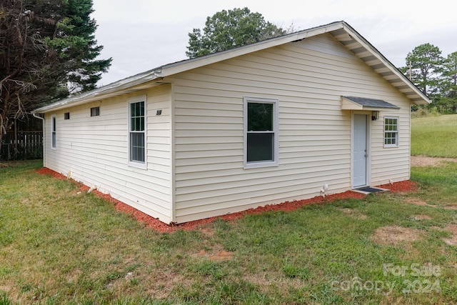 view of side of home featuring a yard