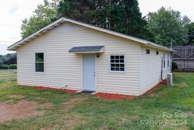 rear view of house with a yard