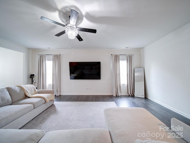 living room featuring ceiling fan, a healthy amount of sunlight, and dark hardwood / wood-style floors