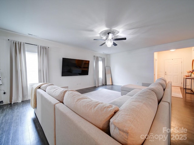 living room with ceiling fan and dark hardwood / wood-style flooring