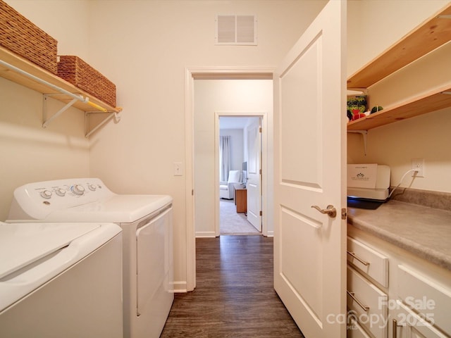 laundry room with washer and clothes dryer and dark hardwood / wood-style floors