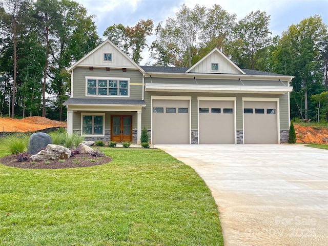 craftsman house with french doors, a garage, and a front lawn