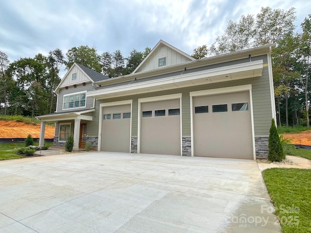 craftsman inspired home featuring a garage and a porch