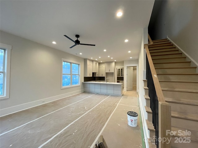 interior space with ceiling fan and sink