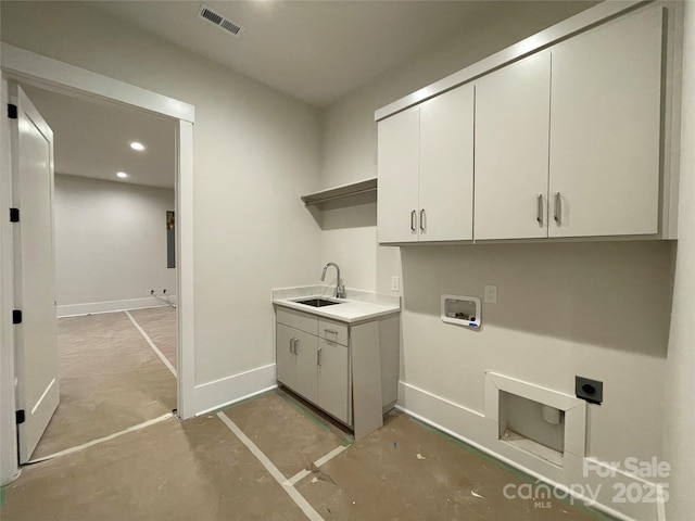 washroom with cabinets, washer hookup, sink, and electric dryer hookup