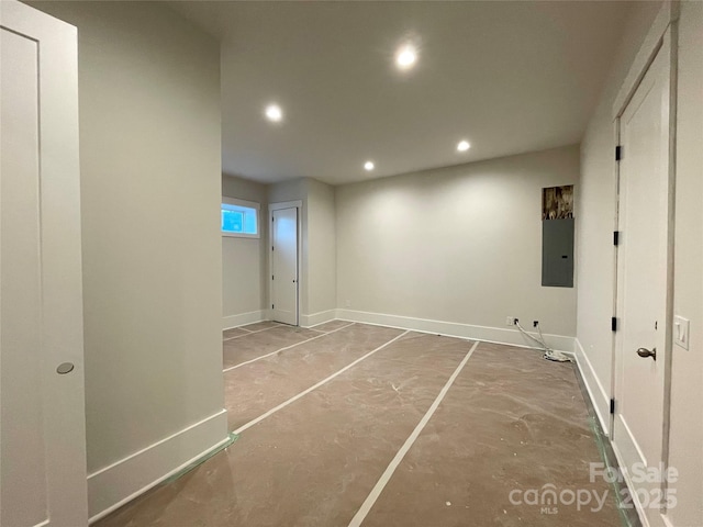 interior space with electric panel and concrete floors