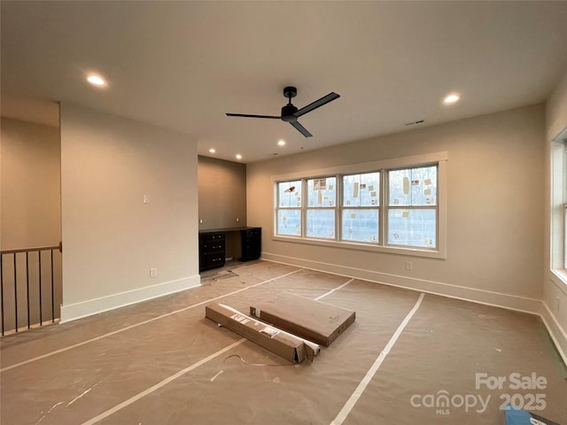 unfurnished living room with ceiling fan