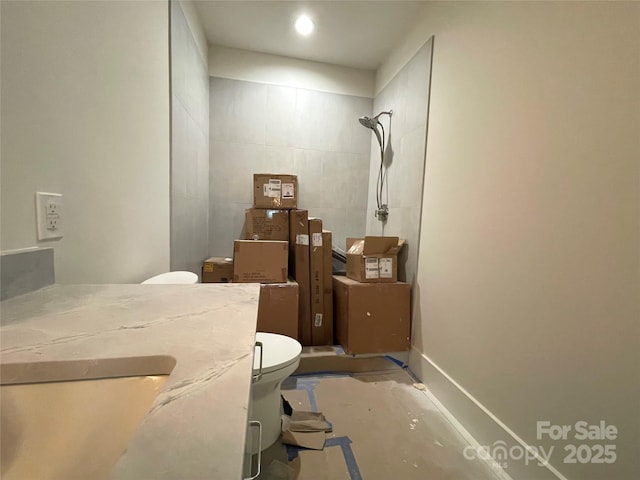 bathroom featuring concrete flooring, toilet, and walk in shower