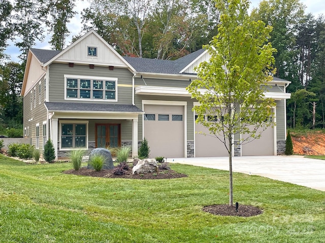 craftsman-style home featuring a garage, a front yard, and french doors