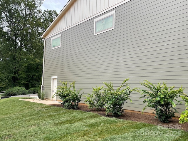 view of side of home featuring a yard