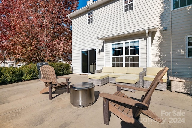 view of patio / terrace with an outdoor living space with a fire pit