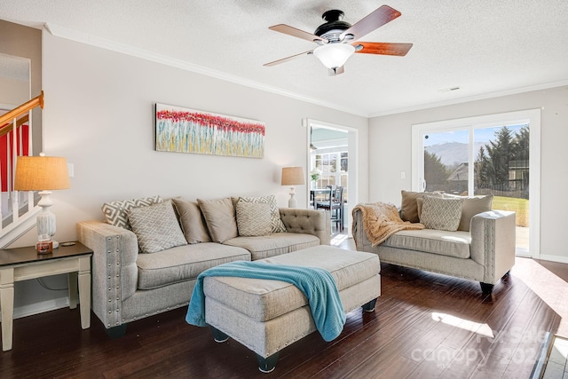 living room featuring dark wood-type flooring, a textured ceiling, and ceiling fan