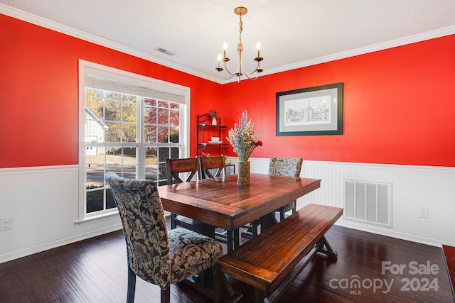 dining space with a notable chandelier, ornamental molding, a textured ceiling, and dark hardwood / wood-style flooring