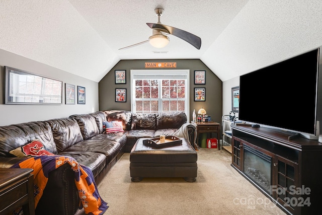 carpeted living room featuring ceiling fan, a textured ceiling, and vaulted ceiling