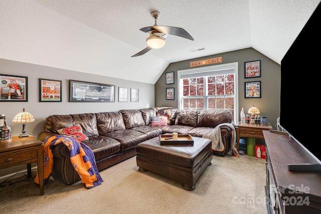 living room with light carpet, a textured ceiling, lofted ceiling, and ceiling fan