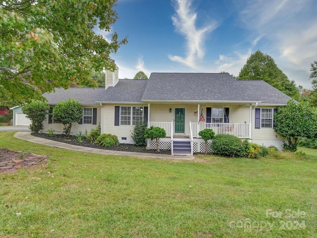 ranch-style home featuring a front lawn, a porch, and a garage