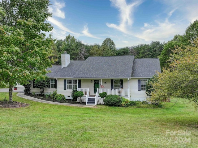 ranch-style home with a front lawn and covered porch