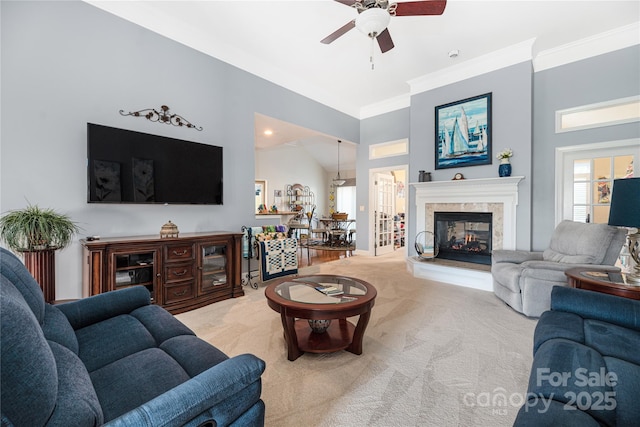 carpeted living room with ceiling fan, a wealth of natural light, ornamental molding, and lofted ceiling