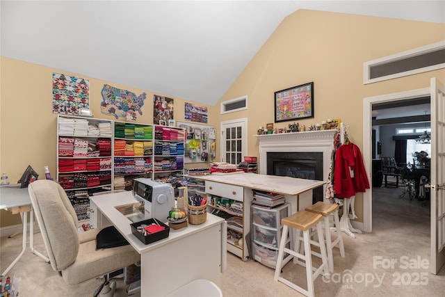 home office with lofted ceiling and light carpet