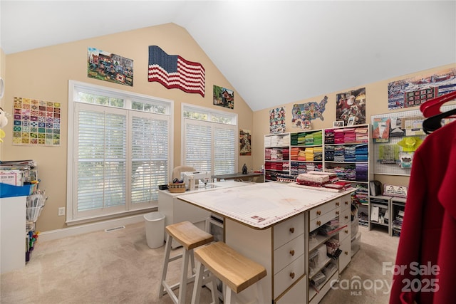 carpeted home office with high vaulted ceiling