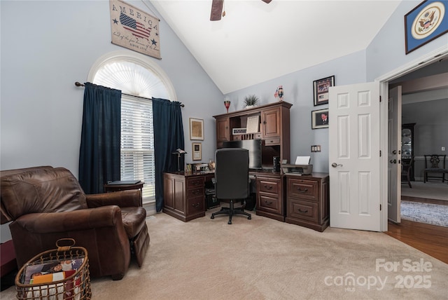 office space featuring ceiling fan, light colored carpet, and high vaulted ceiling