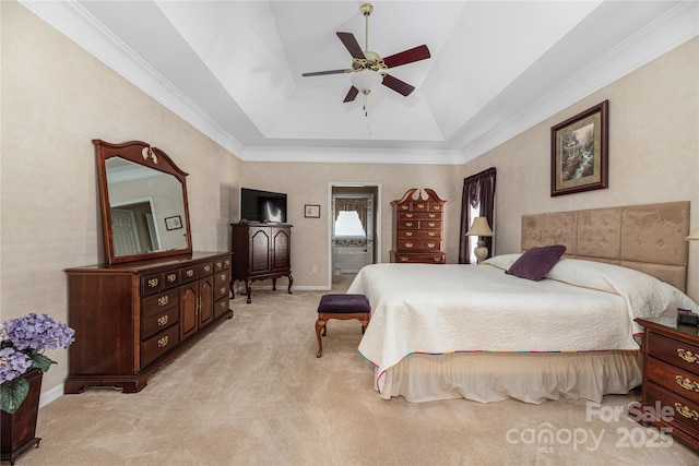 carpeted bedroom with ceiling fan and a raised ceiling