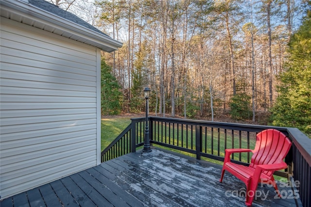 wooden deck with a lawn