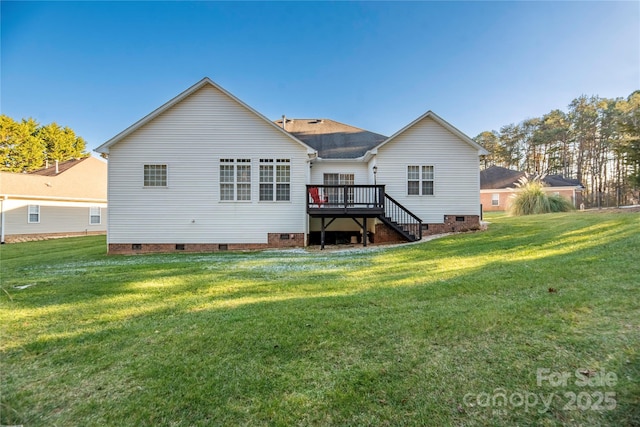 rear view of house featuring a deck and a lawn