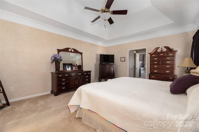 bedroom with ceiling fan, light colored carpet, a tray ceiling, and ornamental molding