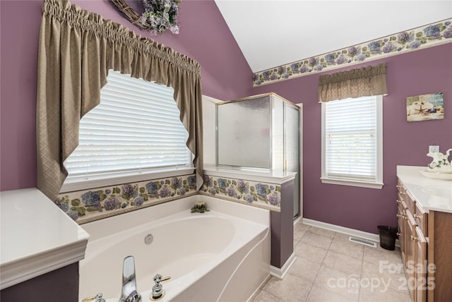 bathroom featuring plus walk in shower, lofted ceiling, tile patterned floors, and vanity