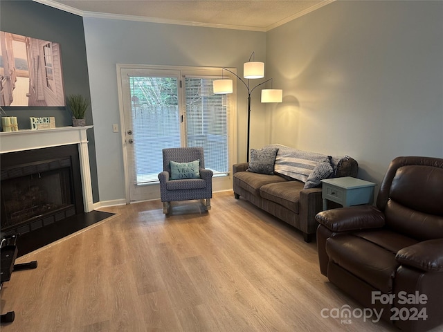 living room featuring light hardwood / wood-style flooring and ornamental molding