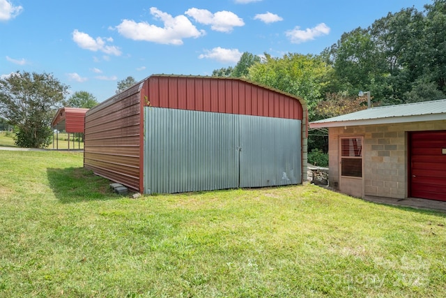 view of outbuilding featuring a lawn