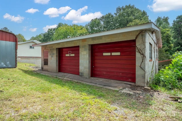 garage featuring a yard