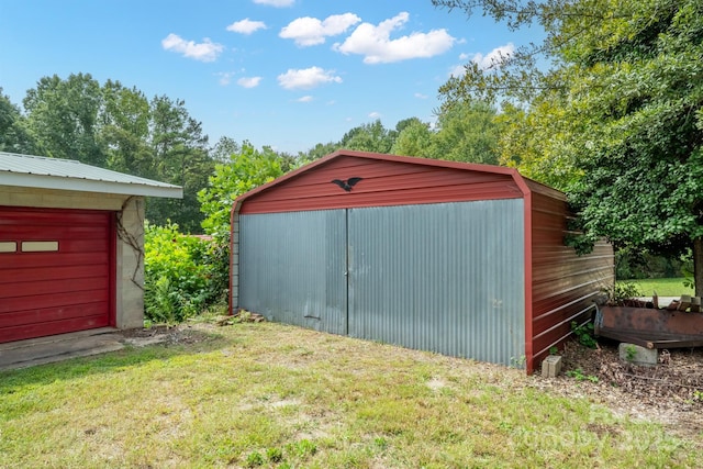 view of outbuilding featuring a yard