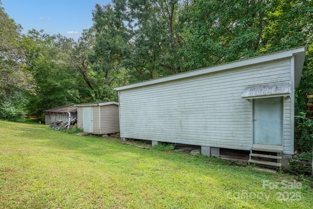 view of outbuilding with a lawn