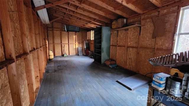 miscellaneous room with a wealth of natural light, dark hardwood / wood-style flooring, and vaulted ceiling