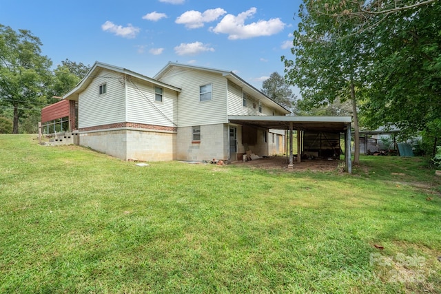 back of property featuring a lawn and a carport