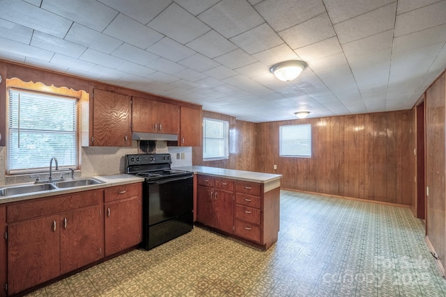 kitchen featuring under cabinet range hood, a sink, black electric range, light countertops, and light floors