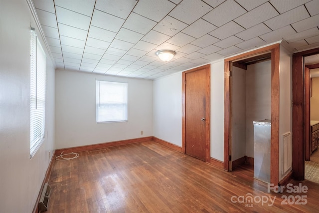 unfurnished bedroom featuring dark hardwood / wood-style flooring