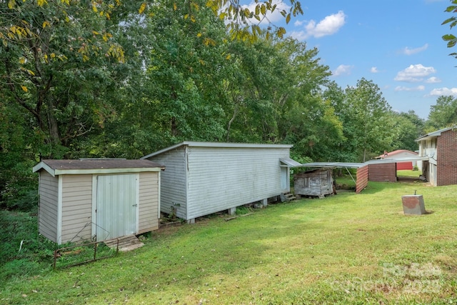 view of yard featuring a storage shed and an outbuilding