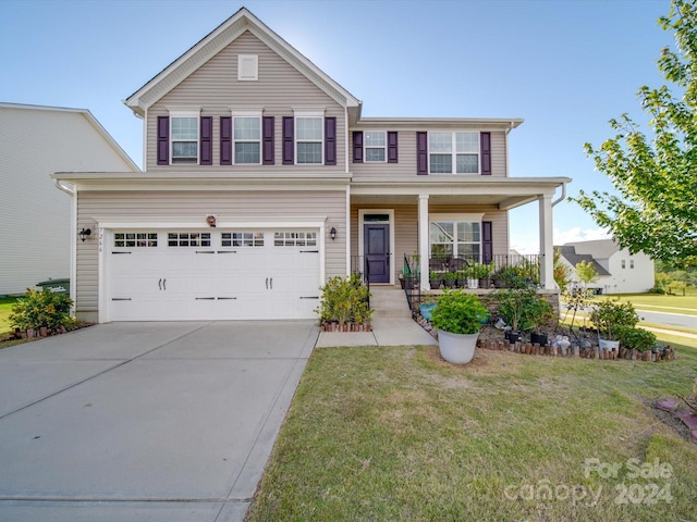 view of front of house featuring a porch, a garage, and a front lawn