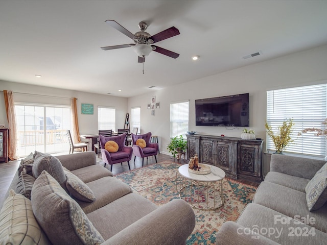 living room with ceiling fan and hardwood / wood-style flooring