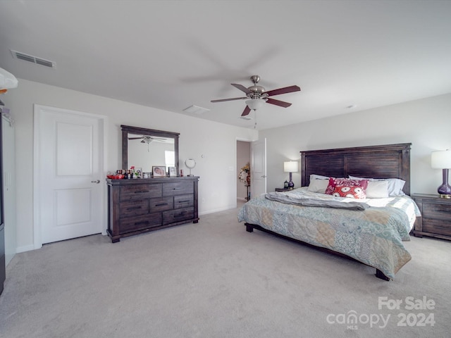 bedroom with ceiling fan and light carpet