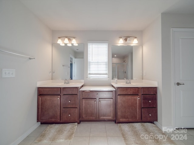 bathroom with tile patterned floors, vanity, and walk in shower