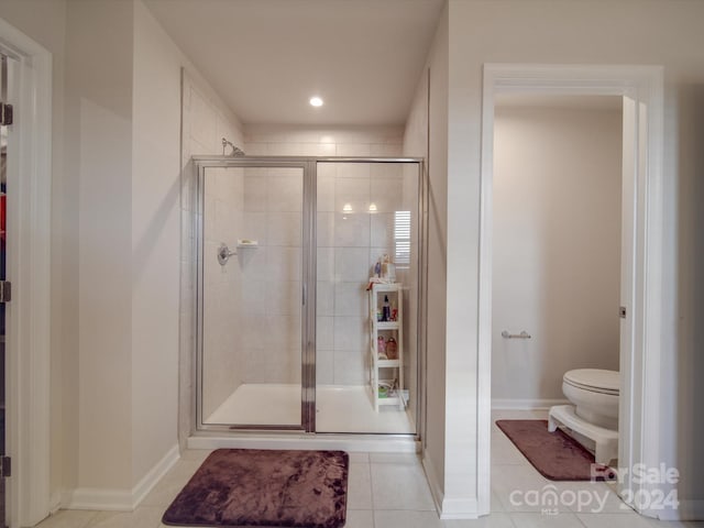 bathroom featuring toilet, tile patterned floors, and walk in shower