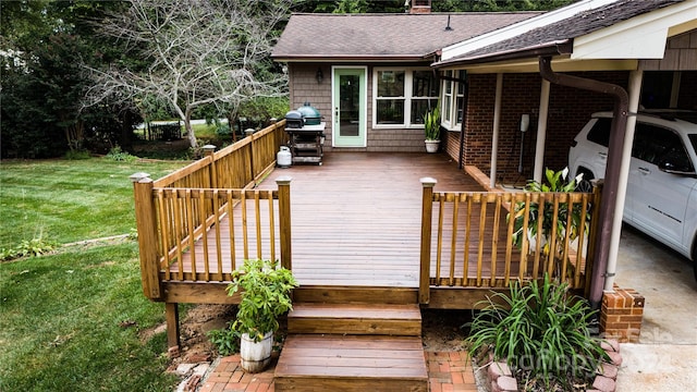 wooden terrace with area for grilling and a lawn