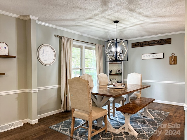 dining room with crown molding, dark wood-type flooring, and a chandelier