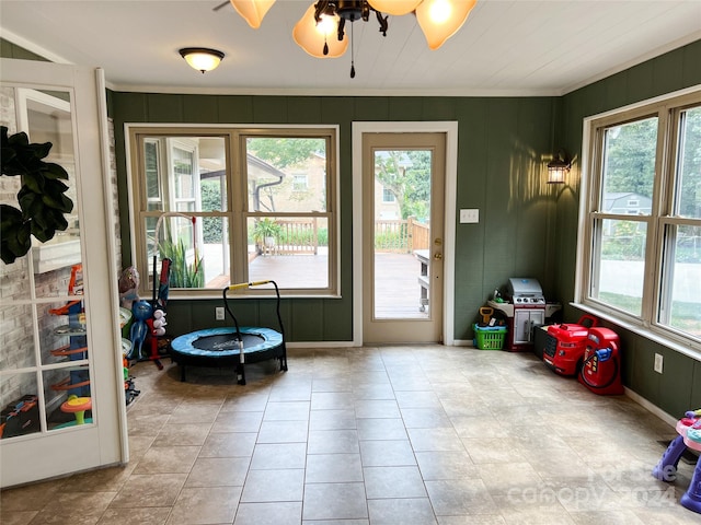 doorway to outside featuring ceiling fan and light tile patterned floors