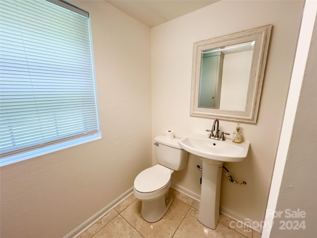 bathroom with tile patterned flooring and toilet