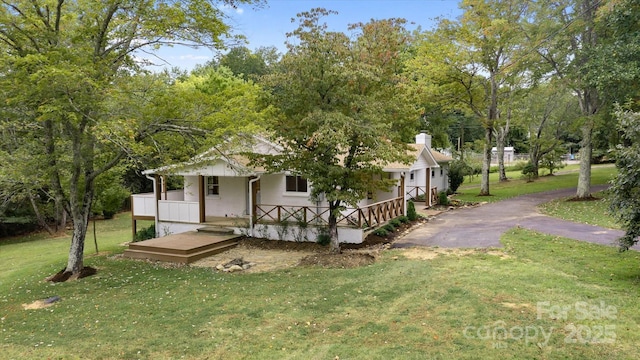 view of front facade with a front lawn, a porch, and stucco siding